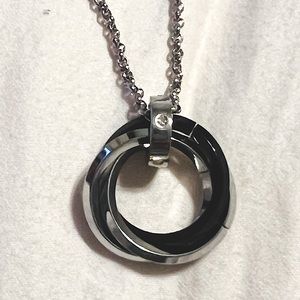 22” chain with a triple circle charm. Silver tone with 2 silver & 1 black circle
